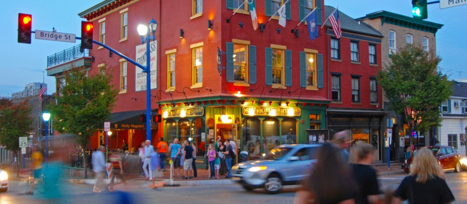 Downtown Bridge Street in Phoenixville, PA, lined with shops, restaurants, and historic storefronts